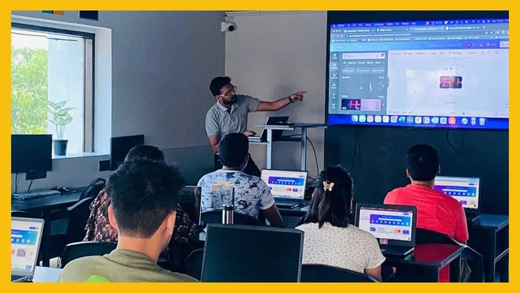 attending a practical digital marketing classroom session at a training institute with a trainer providing hands-on guidance.